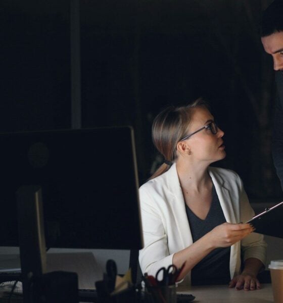 Two colleagues working late in a dimly lit office