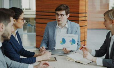Man presenting charts to colleagues in a meeting