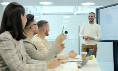 Man presenting to colleagues in a modern office setting