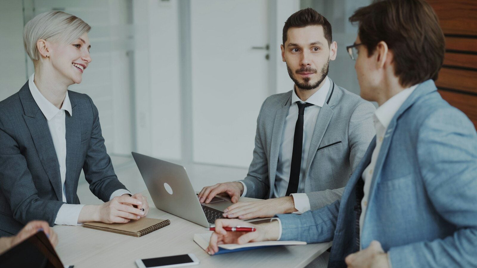 Business professionals in a meeting around a table
