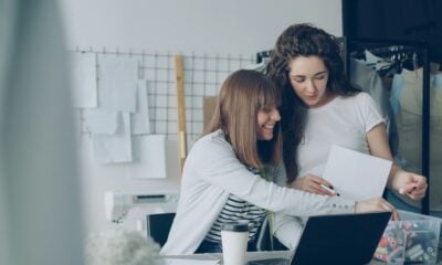 Two women are looking over papers