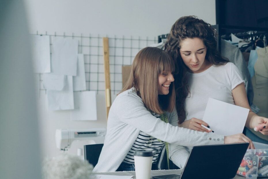 Two women are looking over papers