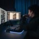 man in black hoodie sitting in front of computer