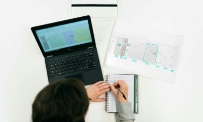 woman in gray sweater using macbook pro