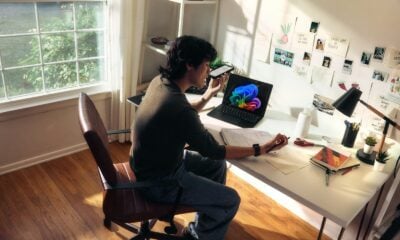 Person working at a desk with a laptop and books