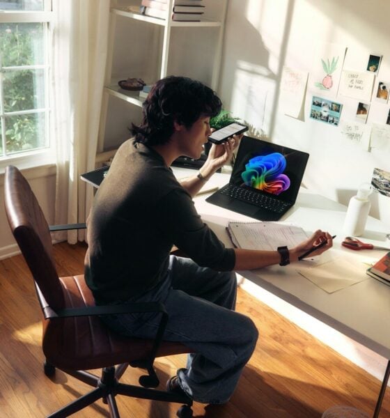 Person working at a desk with a laptop and books