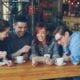 Friends watch a phone in a coffee shop