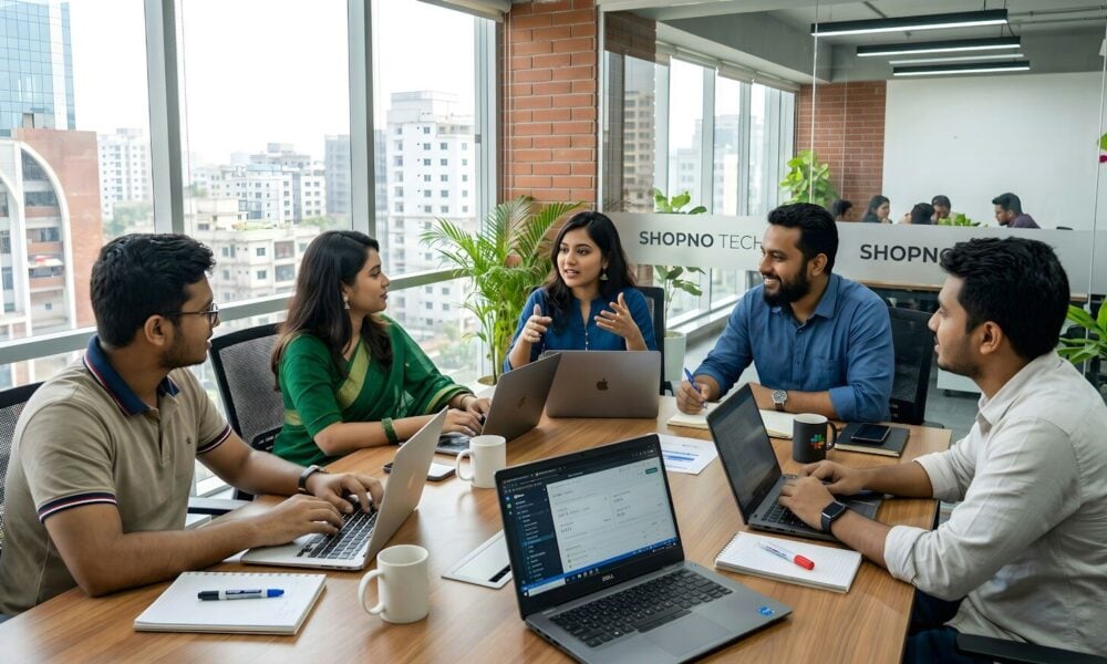 Five colleagues collaborating around a table in a modern office