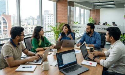 Five colleagues collaborating around a table in a modern office